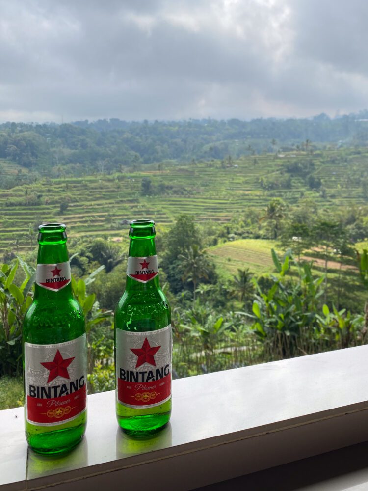 Two Bintang beers set against the backdrop of Jatiluwih Rice Terraces, a UNESCO World Heritage site in Bali.