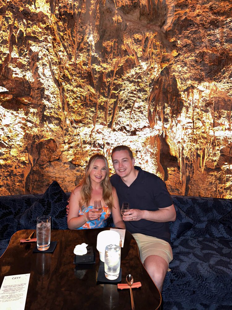 Couple enjoying a tasting experience inside The Cave by Chef Ryan Clift in Uluwatu, surrounded by dramatic limestone walls and ambient lighting.