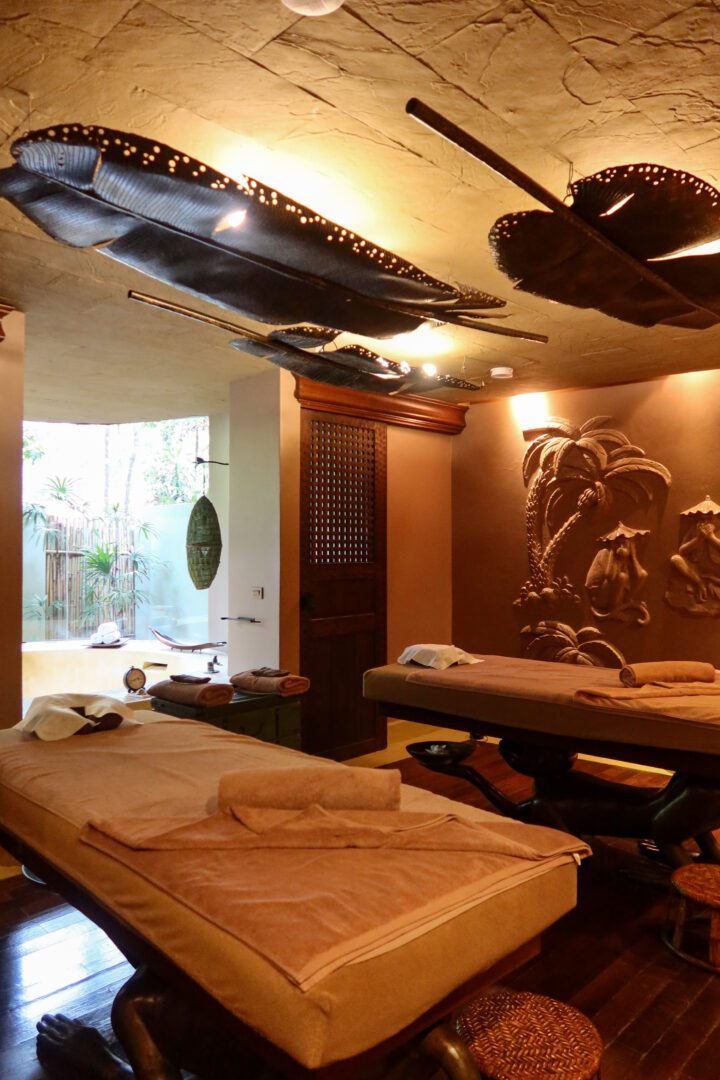 Serene spa treatment room at Rayavadee Resort featuring twin massage tables, tropical-inspired decor, and a tranquil design perfect for couples’ relaxation.