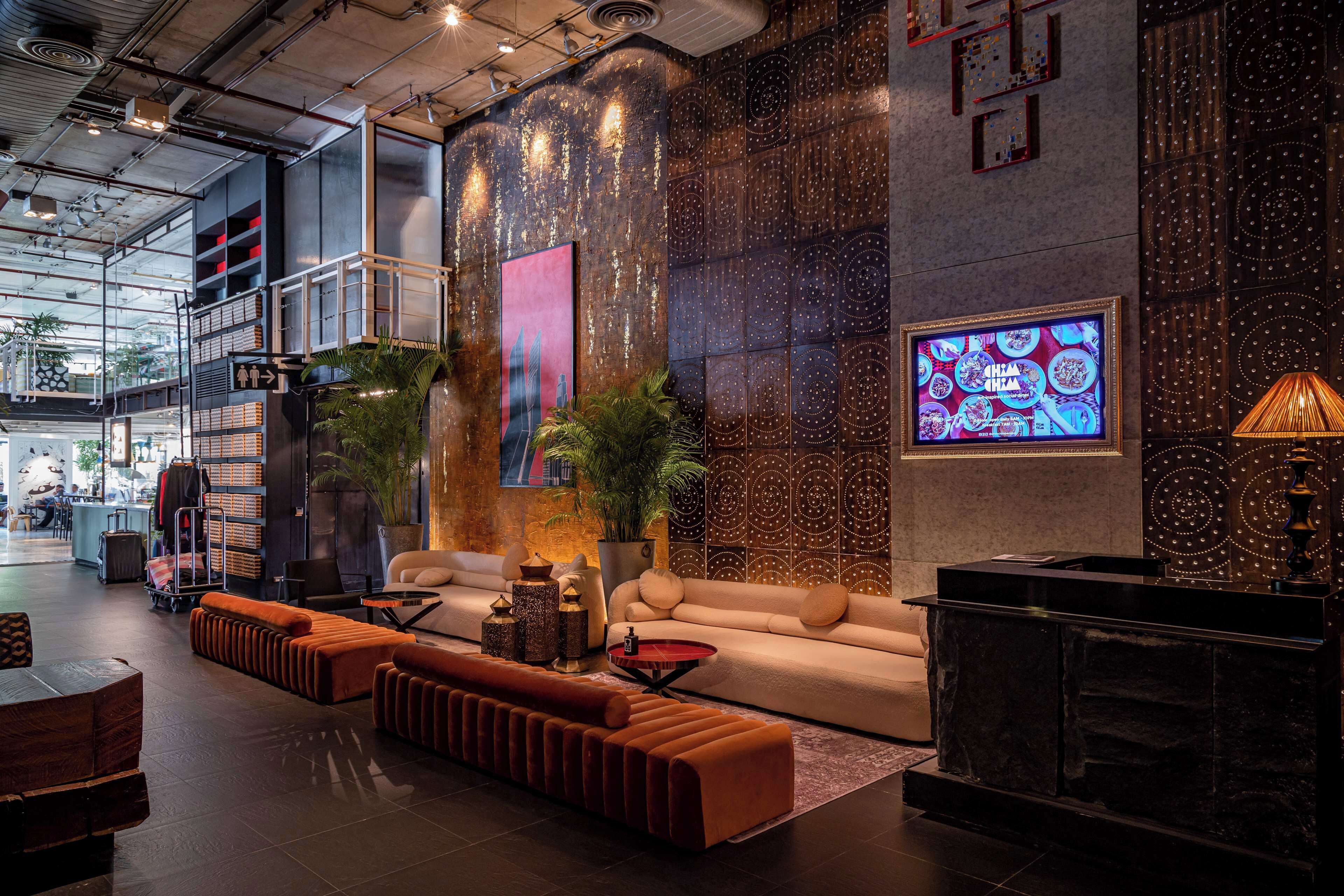 Eclectic and artsy lobby at Siam@Siam Design Hotel Bangkok, blending industrial chic with bold textures, ambient lighting, and contemporary Thai-inspired décor.