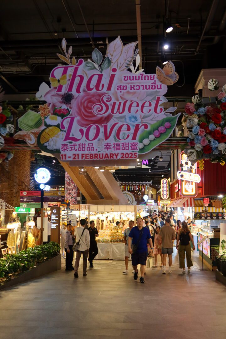 Decorative entrance sign for the "Thai Sweet Lover" festival at a Bangkok shopping mall, welcoming visitors to a colorful dessert-themed event.