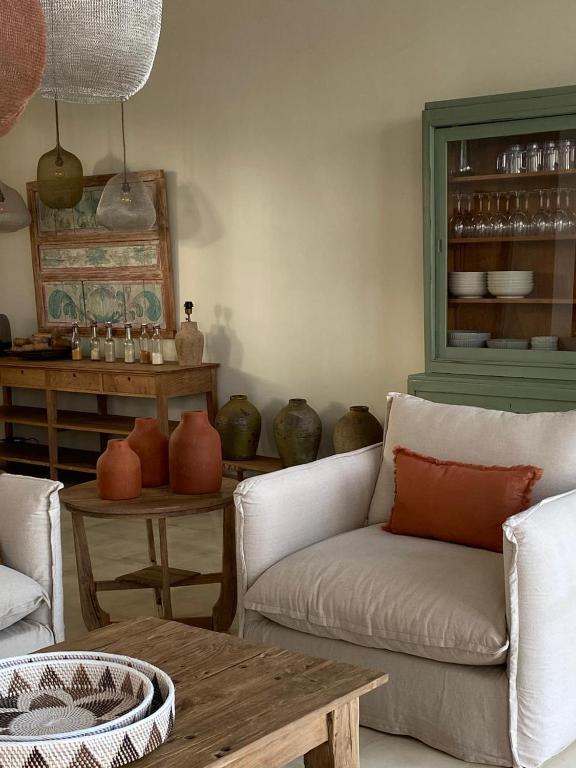 Cozy, rustic-chic villa interior at Villa Sowilo in Nusa Penida with earth-toned decor, clay pottery, and artisan furnishings.