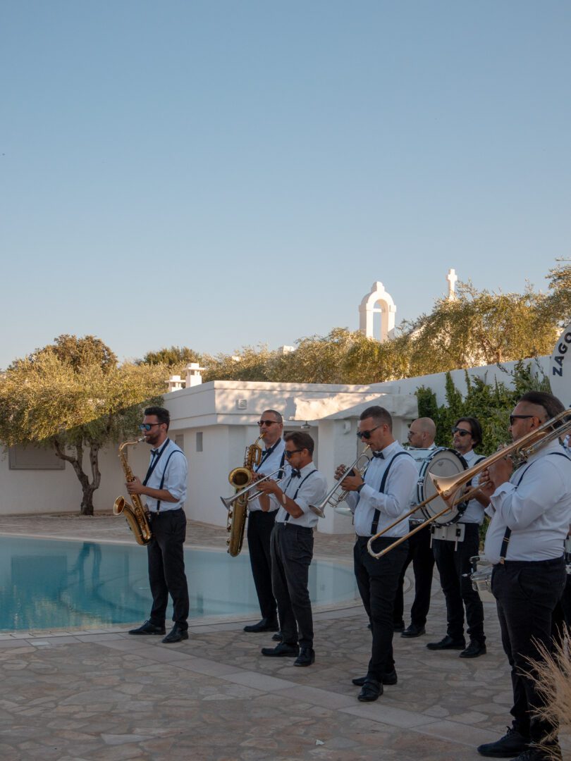 Live band playing by the pool during cocktail hour at a wedding in Puglia, Italy.