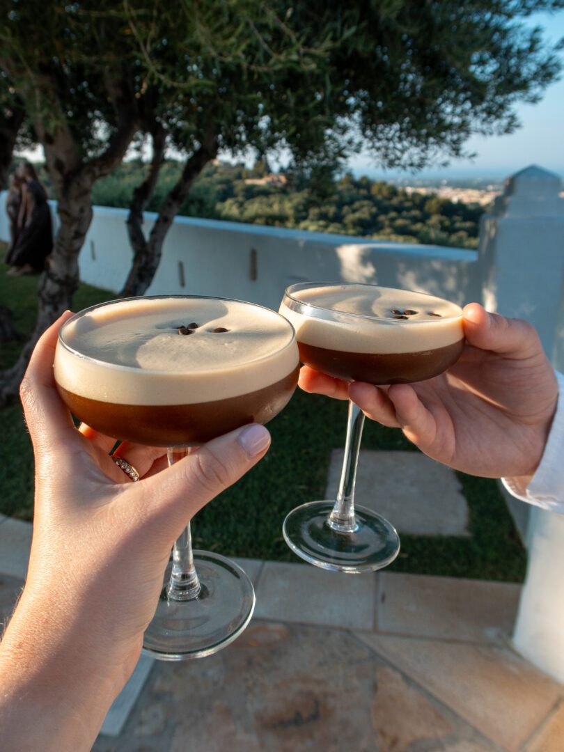 Toasting with espresso martinis on the terrace at Masseria Borgo Ritella, with sweeping views of Puglia’s countryside in golden hour light.
