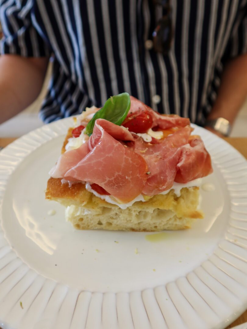 Focaccia topped with Parma ham, burrata, cherry tomatoes, and basil at Casa e Bottega in Positano.