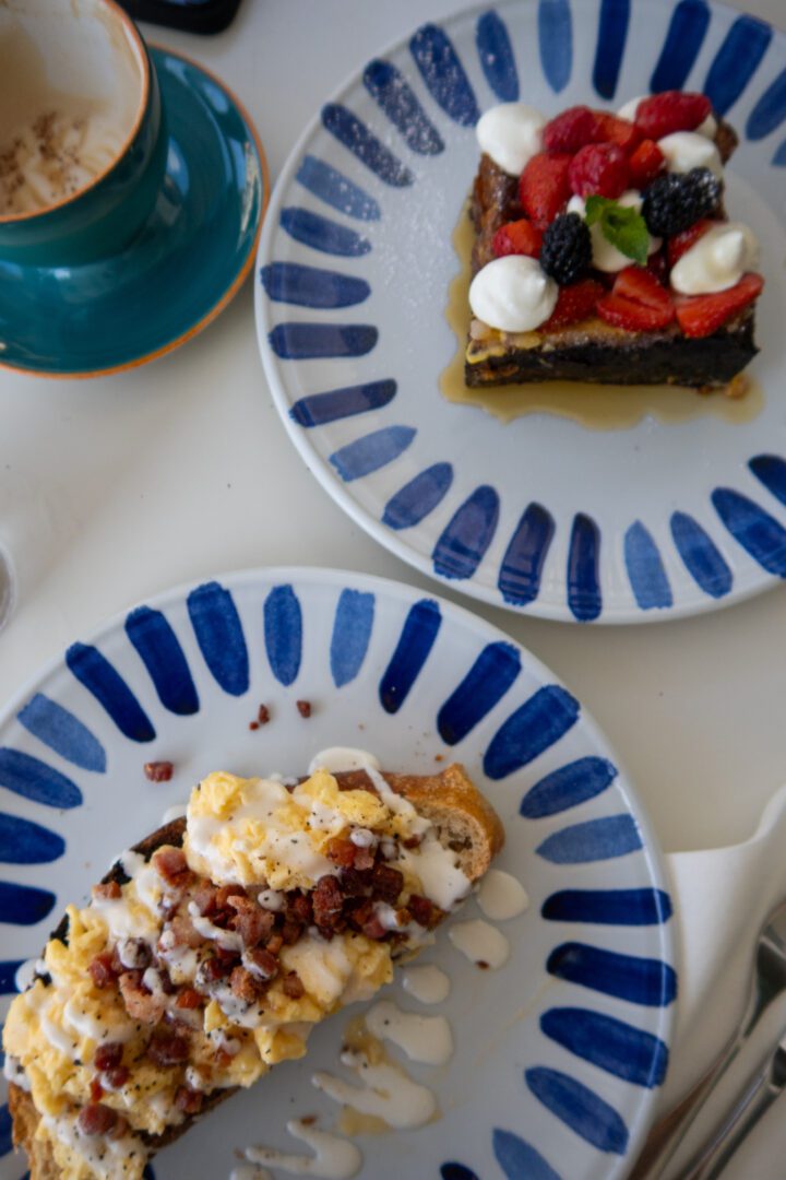 Brunch spread at Posides restaurant in Positano featuring carbonara toast with pancetta and a slice of berry-topped French toast.
