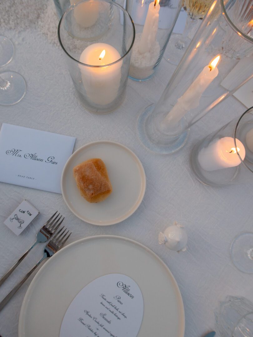 Elegant candlelit table setting with custom menu at a Masseria Borgo Ritella wedding reception.