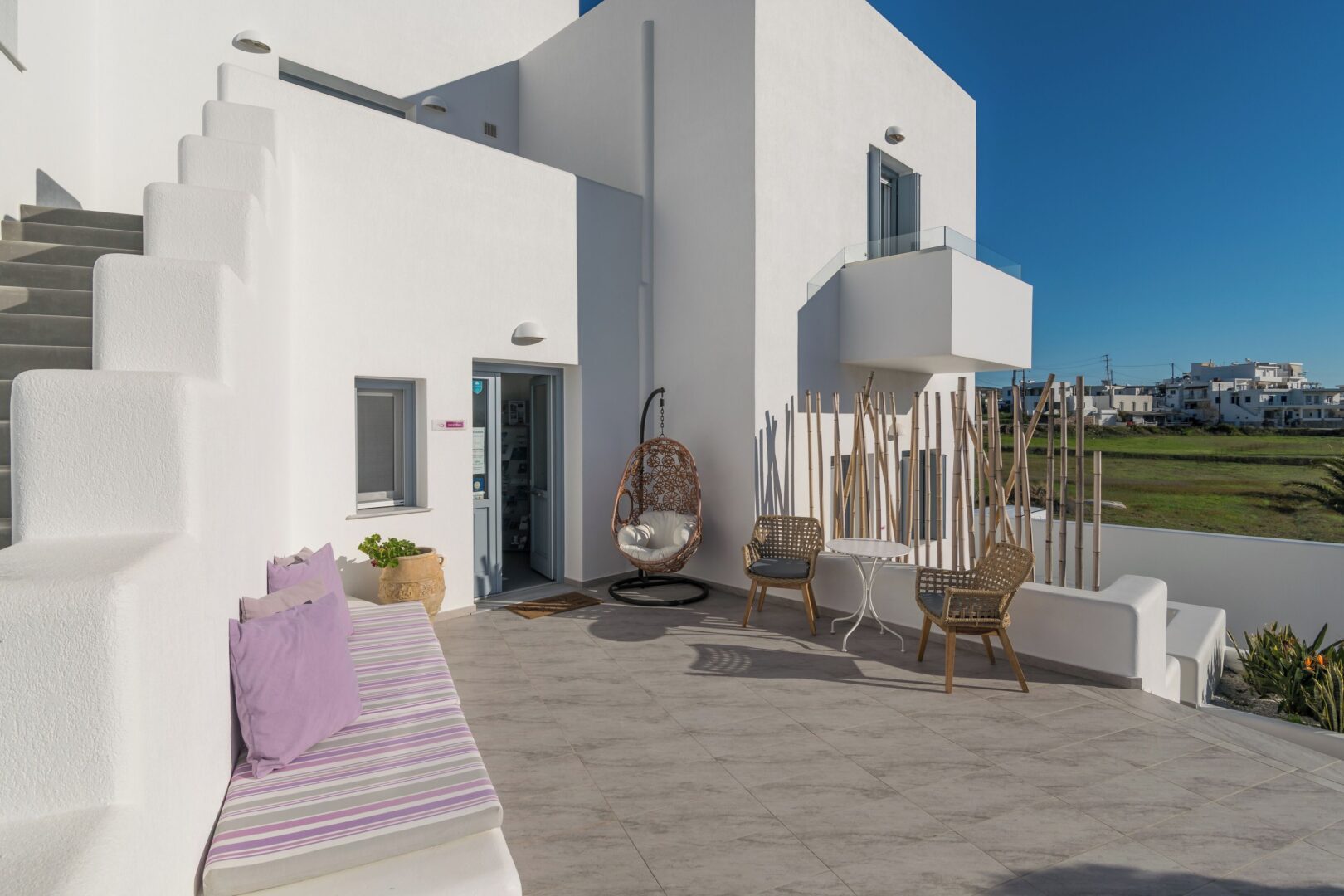 Tranquil courtyard at Tsakanos Home Milos with a minimalist design, cozy seating areas, and views across the countryside.
