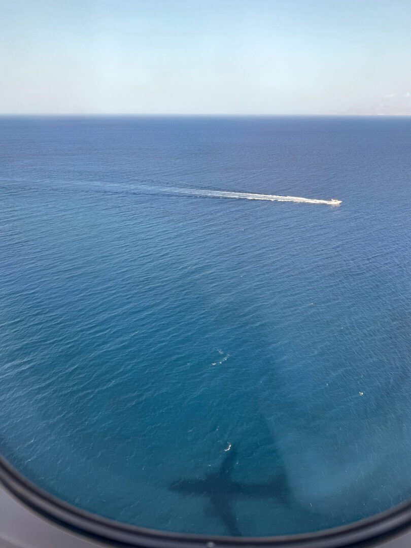 View of the Aegean Sea from an airplane window en route to our Santorini Greece vacation.