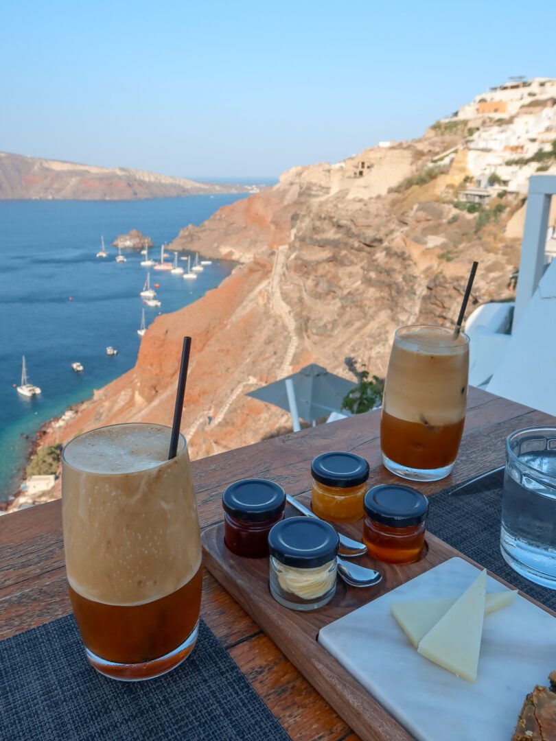 Iced Greek frappes with bread, cheese, and jam served at breakfast with caldera views at Katikies Hotel Santorini.