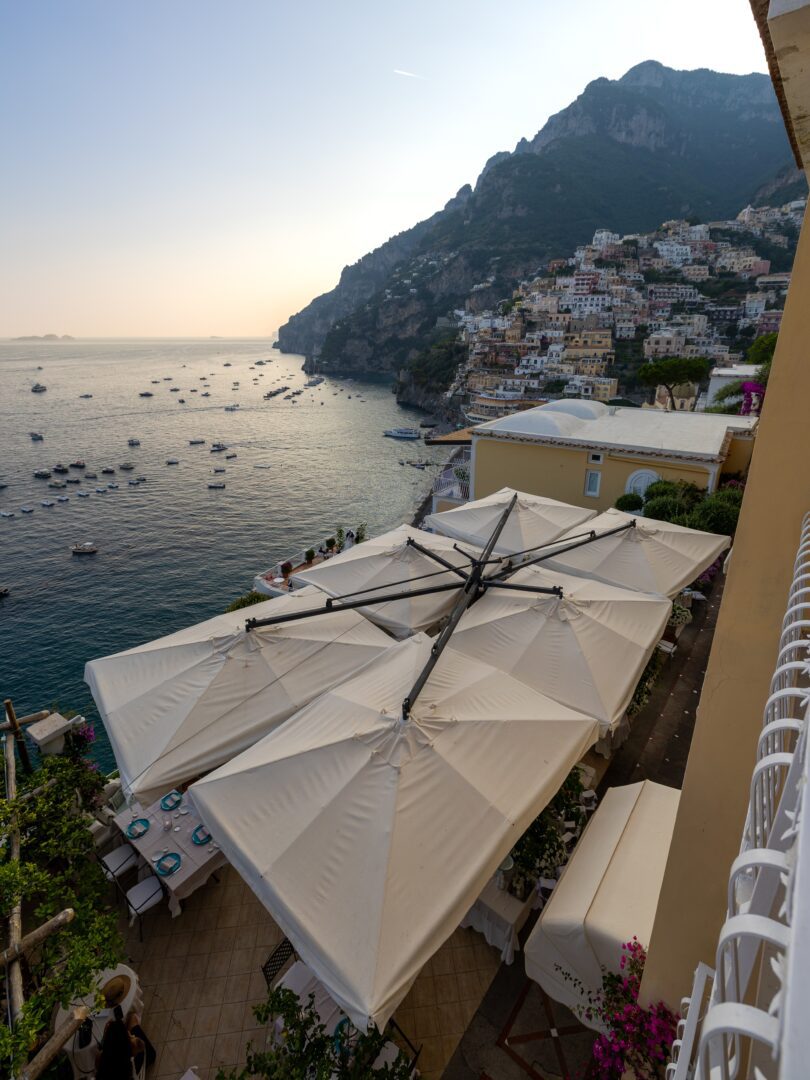 Golden hour view of Positano’s cliffside homes and the Tyrrhenian Sea from a balcony at Hotel Marincanto.
