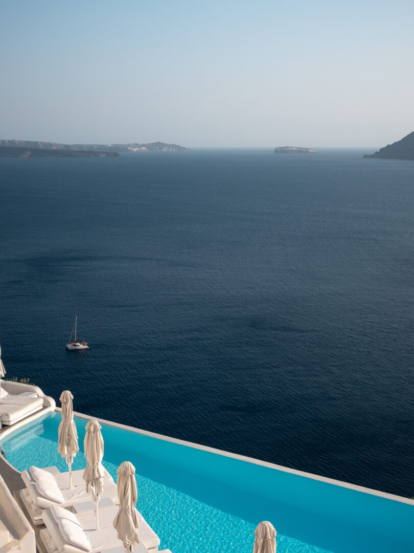 Infinity pool at Katikies Hotel overlooking the deep blue Aegean Sea and caldera cliffs, the perfect place to stay on a Santorini Greece vacation.