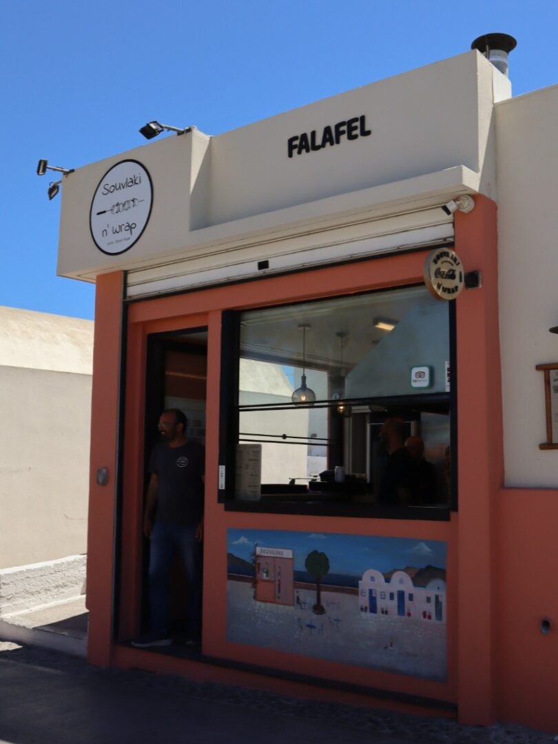 Storefront of Souvlaki N’ Wrap in Oia, Santorini, a popular spot for gyros, souvlaki, and casual Greek eats.
